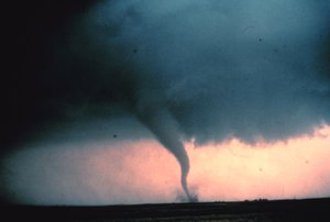 Tornado with dust and debris cloud forming at surface