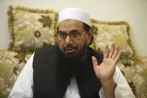 Hafiz Saeed talks to The Associated Press in Lahore, Pakistan. Roaming freely in Pakistan, despite a $10 million bounty on his head, one of India’s most wanted men, Saeed warns of demonstrations countrywide to force Pakistan