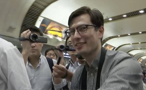 In this image made from video, Australian student Alek Sigley smiles as he arrives at the airport in Beijing on Thursday, July 4, 2019.