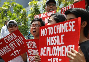 Protesters shout slogans during a rally at the Chinese Consulate to protest China's deployment of missiles on the Philippine-claimed reefs in South China Sea Thursday, May 10, 2018 in the financial district of Makati city east of Manila, Philippines. The protesters condemned China for