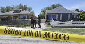 Police officers stand in front of the home, right, of Ayoola A. Ajayi Friday, June 28, 2019, in Salt Lake City.