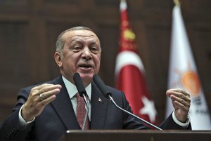 Turkey's President Recep Tayyip Erdogan delivers a speech to members of parliament of his ruling Justice and Development Party at the parliament in Ankara, Turkey, Tuesday, Nov. 27, 2018