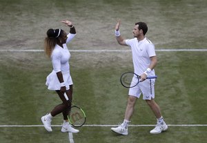 Serena Williams makes a high five with Britain's Andy Murray