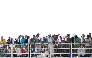 Migrants wait to disembark from the ' The Phoenix ' a Malta-based Migrant Offshore Aid Station, in the Sicilian harbor of Pozzallo, Italy, Tuesday May 5, 2015.