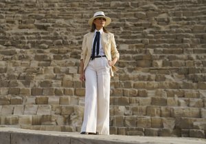 First lady Melania Trump pauses for photographs as she visits the historical site of the Giza Pyramids in Giza, near Cairo, Egypt. Saturday, Oct. 6, 2018