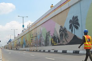 File - This is an image of "African people at work" from Nigeria. Mural/Graffiti Art is currently on the rise in Lagos, Nigeria - Africa's most populous and largest economy.