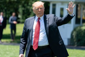 President Donald Trump waves to guests and staff attending his departure as he walks to Marine One across the South Lawn of the White House Tuesday, June 11, 2019, for his flight to Joint Base Andrews, Md., to begin his trip to Iowa.