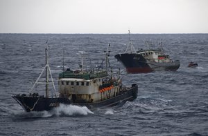 (Oct. 8, 2007) ONBOARD THE USCGC BOUTWELL - Boarding teams, from the U.S. Coast Guard Cutter Boutwell, boarded the Fishing Vessels Lu Rong Yu 2659 (front) and 2660 (back). The boarding team quickly determined that both the Lu Rong Yu 2659 and 2660 were rigged for high-seas drift net fishing and is currently escorting the vessels, along with one other vessel, back into Chinese custody. The Boutwell is currently deployed as U.S. Coast Guard representatives in the North Pacific Coast Guard Forum (NPCGF). This forum was developed to combat illegal fishing and increase international maritime safety and security on the Northern Pacific Ocean and its borders. (Coast Guard photo by Petty Officer Jonathan R. Cilley) (170236) ( Boutwell captures three high seas drift net fishing vessels (FOR RELEASE) )