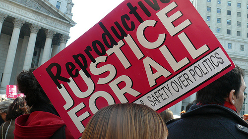 Banner at rally reads Reproductive Justice for All