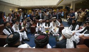 FILE - In this file photo taken on Tuesday, May 28, 2019, Mullah Abdul Ghani Baradar, the Taliban group's top political leader, left, Sher Mohammad Abbas Stanikzai, the Taliban's chief negotiator, second left, and other members of the Taliban delegation speak to reporters prior to their talks in Moscow, Russia. The seventh and latest round of peace talks between the U.S. and Taliban is "critical," said Taliban spokesman Suhail Shaheen on Sunday June 30, 2019.