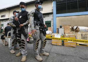 File - Philippine Drug Enforcement Agency (PDEA) agents guard P3.1 million ($62,000) worth of chemicals and laboratory equipment recently seized in President Rodrigo Duterte's ongoing efforts to stop the drug trade prior to being destroyed, Thursday, Dec. 8, 2016, in Valenzuela city, Philippines.