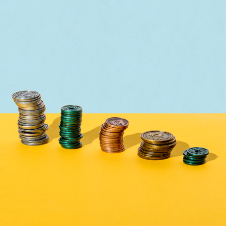 Piles of play money coins in descending order of height