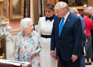 File - President Donald J. Trump and First Lady Melania Trump review items from the Royal Collection with Britain’s Queen Elizabeth II Monday, June 3, 2019, in the Picture Gallery at Buckingham Palace in London.