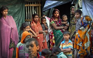 Rohingya Hindu refugees stand outside their make shift shelters at Kutupalong refugee camp near Cox's bazar, Bangladesh, Tuesday, Jan. 16, 2018. Bangladesh and Myanmar have agreed that they will try to complete the repatriation of hundreds of thousands of Rohingya Muslim refugees who fled from violence in Myanmar within two years, Bangladesh's Foreign Ministry said Tuesday. (AP Photo/Manish Swarup)