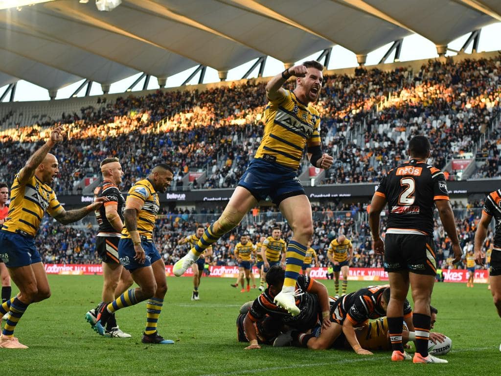 Clint Gutherson of the Eels celebrates as teammate Brad Takairangi scores a try during the Round 17 NRL match between the Wests Tigers and the Parramatta Eels at Bankwest Stadium in Sydney, Sunday, July 14, 2019. (AAP Image/Joel Carrett) NO ARCHIVING, EDITORIAL USE ONLY