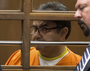 Naason Joaquin Garcia, the leader of Mexican megachurch La Luz del Mundo, behind bars, listens to a court interpreter as he appears with his attorneys in Los Angeles County Superior Court on Friday, June 21, 2019. Naasón Joaquín García, the church's self-proclaimed apostle, poses a threat to