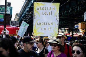 People hold signs calling for the abolition of Immigration and Customs Enforcement at a rally before the start of a march in opposition to the Trump administration’s plans to continue with raids to catch immigrants in the country illegally, Sunday, July 14, 2019, in the Queens borough of New York.