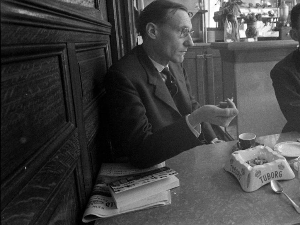 William S. Burroughs with a copy of Naked Lunch at the Beat Hotel, 1959