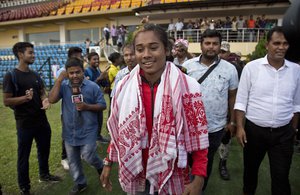 Indian athlete Hima Das who won gold and silver medals in Asian Games comes to offer prayer on the track after her arrival in Gauhati, India, Friday, Sept. 7, 2018, (AP Photo/Anupam Nath)