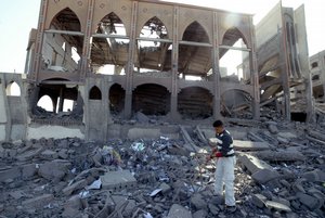 Palestinians collect belongings from the rubble