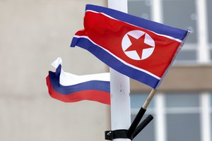 Flags of Russia and North Korea are seen along the road on Russky Island, in Vladivostok, Russia, Wednesday, April 24, 2019.