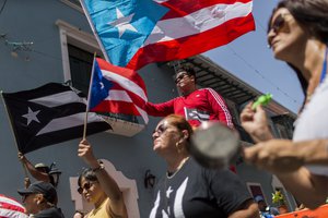 Demonstrators, some waving Puerto Rican national flags, gather in front of the governor's mansion La Fortaleza, in San Juan, Puerto Rico, Wednesday, July 24, 2019.