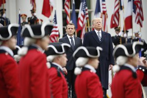 President Donald Trump and French President Emmanuel Macron stand during a State Arrival Ceremony on the South Lawn of the White House in Washington, Tuesday, April 24, 2018.