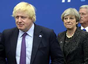 File - In this Thursday, May 25, 2017 file photo British Foreign Secretary Boris Johnson, left, and Britain's Prime Minister Theresa May arrive for a meeting during the NATO summit of heads of state and government, at the NATO headquarters, in Brussels.