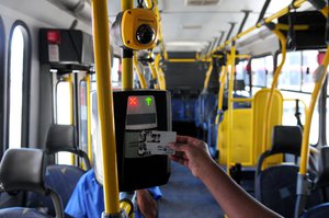 File - Passenger using biometric facial recognition at the entry of the Distrito Federal's bus, Brasilia