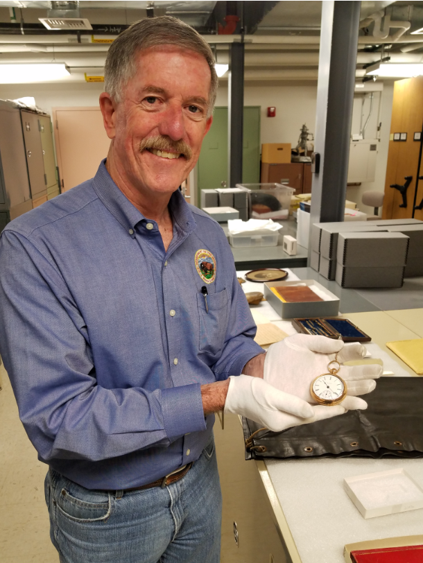 USGS Director Jim Reilly holds J.W. Powell's watch.