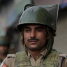 Indian soldiers patrol in Srinagar, India, on Sunday amid rising tensions.