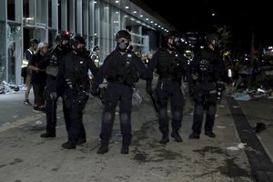 File photo:  Police officers with protective gear prepare to clear protesters from the Legislative Council in Hong Kong, during the early hours of Tuesday, July 2, 2019.