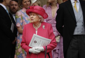 Britain's Queen Elizabeth II, center, stands with guests as she leaves the chapel after the wedding of Lady Gabriella Windsor and Thomas Kingston at St George's Chapel, Windsor Castle, near London, England, Saturday, May 18, 2019.