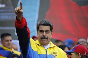 FILE - In this Aug. 10, 2019 file photo, Venezuela's President Nicolas Maduro lead a rally condemning the economic sanctions imposed by the administration of U.S. President Donald Trump on Venezuela, in Caracas, Venezuela.