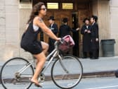 A cyclist passes Hasidic Jews outside of a synagogue on Bedford Avenue in the Brooklyn borough of New York, Aug. 13, 2013.