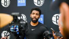 Brooklyn Nets guard Kyrie Irving (11) speaks to