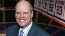 Islanders radio announcer Chris King poses before a