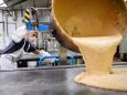 An employee pours English toffee inside the Nassau