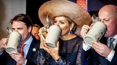 Dutch Queen Maxima (C) drinks beer in a