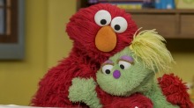 Sesame Street is exploring the backstory of Karli, a bright green, yellow-haired friend of Elmo's whose mother is ...