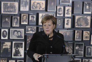 German Chancellor Angela Merkel speaks in the building of the so-called "Sauna" during her visit at the former Nazi German concentration and extermination camp Auschwitz-Birkenau in Oswiecim, Poland on Friday, Dec. 6, 2019