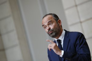 French Prime Minister Edouard Philippe, right, and French Government's Spokesperson Benjamin Griveaux delivers his speech during a joint press conference following the cabinet meeting at the Elysee Palace in Paris, France, Wednesday, May 30, 2018