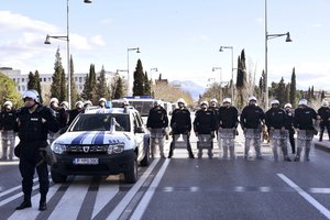 Police officers guard the parliament building in Podgorica, Montenegro, Thursday, Dec. 26, 2019, during a protest against a proposed law regarding religious communities and property