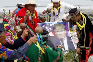 A group of shamans, holding Donald Trump poster perform their annual pre-New Year ceremony in Lima, Peru