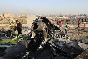 Debris is seen from an Ukrainian plane which crashed as authorities work at the scene in Shahedshahr, southwest of the capital Tehran, Iran, Wednesday, Jan. 8, 2020