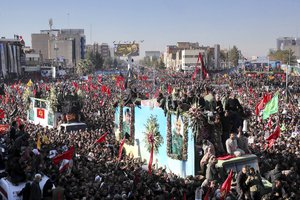 Coffins of Gen. Qassem Soleimani and others who were killed in Iraq by a U.S. drone strike, are carried on a truck surrounded by mourners during a funeral procession, in the city of Kerman, Iran, Tuesday, Jan. 7, 2020.