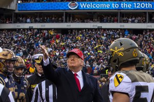 File - President Donald J. Trump tosses the coin at the beginning of the 120th Army-Navy football game in Philadelphia, Dec. 14, 2019.