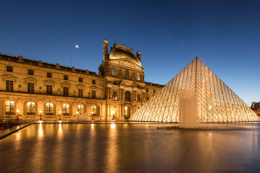 Paris, France - December 3, 2016: The Louvre Museum is one of the most important monument in the World and the new modern glass style pyramid that was built in the 1980s by late French president Mitterrand, stands in the middle of courtyard. sunjan12cover
