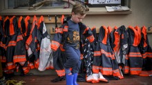 Cooper, from Diamond Creek Memorial Kindergarten, gets into his wet-weather clothing. Every child at the kindergarten is ...