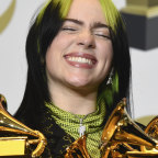 Billie Eilish poses with her Grammy Awards after the ceremony.